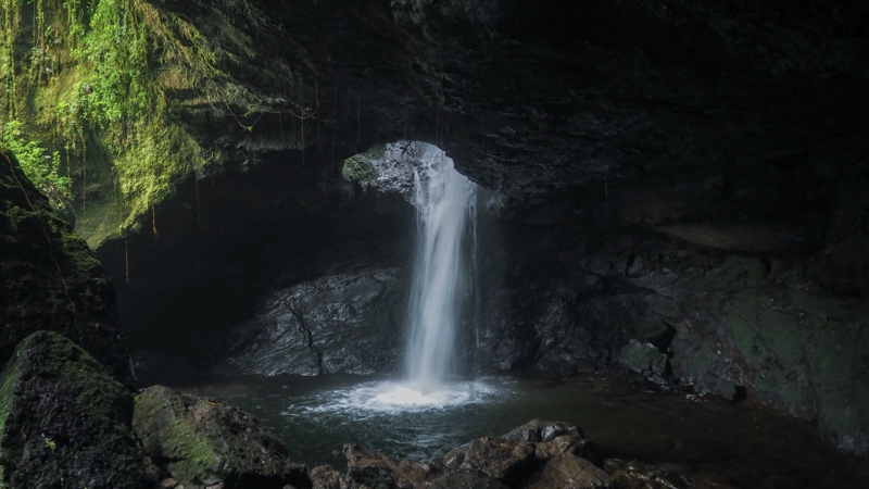 A waterfall inside the Espledor Cave, a place to go caving in Colombia.